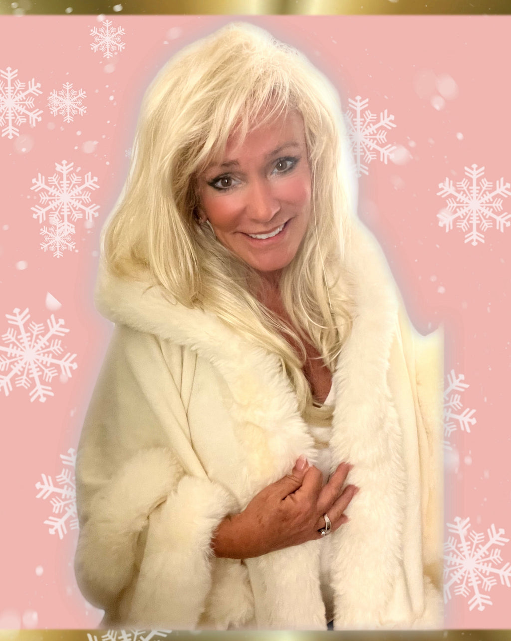 White hooded winter cape with plush fur trim worn by Linda Rick against a pink snowflake background.