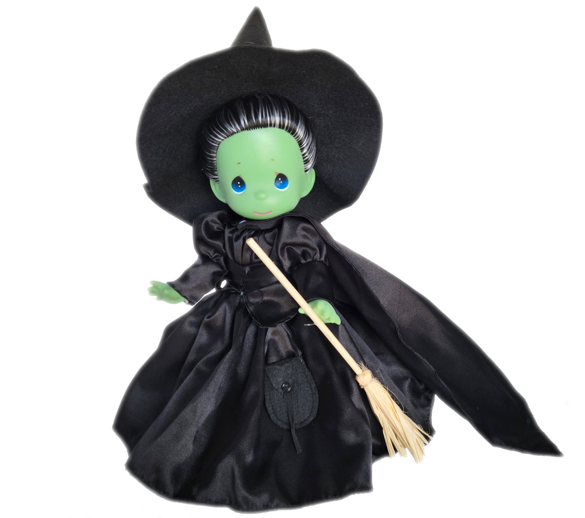 The Doll Maker 12-inch Wicked Witch of the West vinyl doll wearing a black dress and hat with a miniature broomstick
