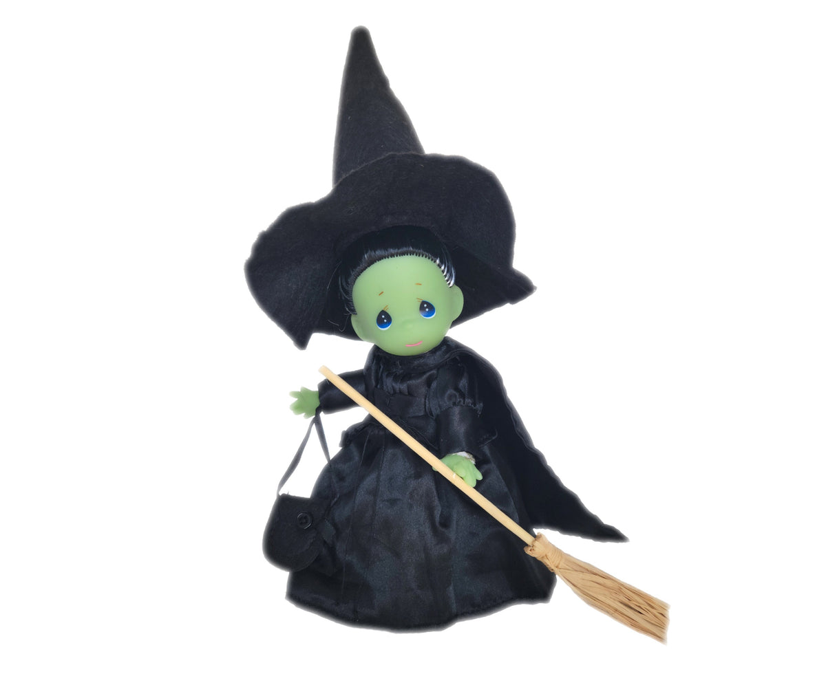 The Doll Maker 7-inch Wicked Witch of the West vinyl doll wearing a black hat and dress with a broomstick