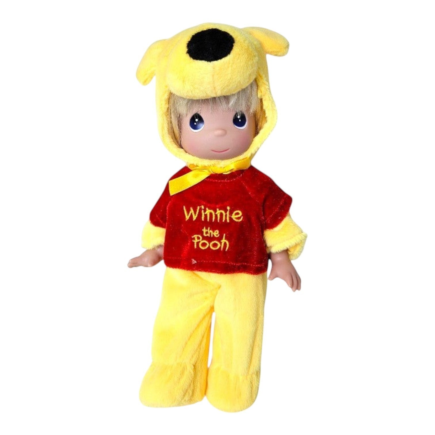 The Doll Maker 12-inch Winnie the Pooh doll wearing a plush yellow and red bear costume with a hood.