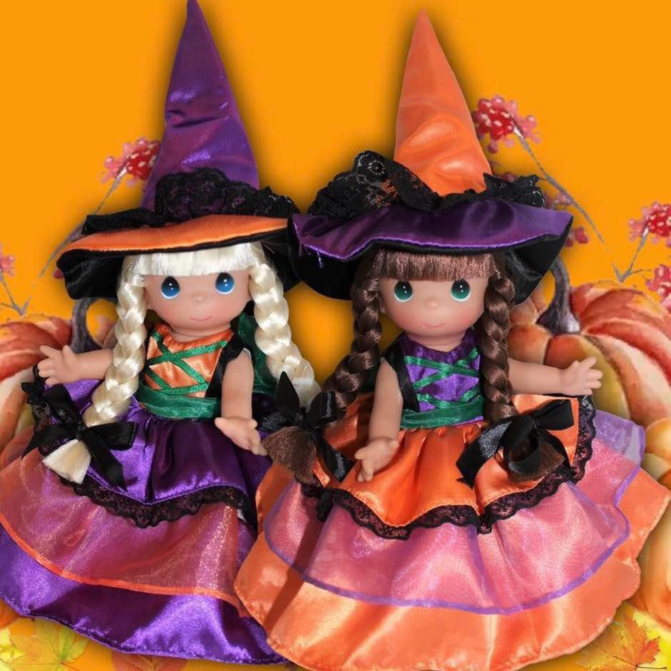 The Doll Maker 9-inch witch dolls with blonde and brunette braids wearing purple and orange satin dresses