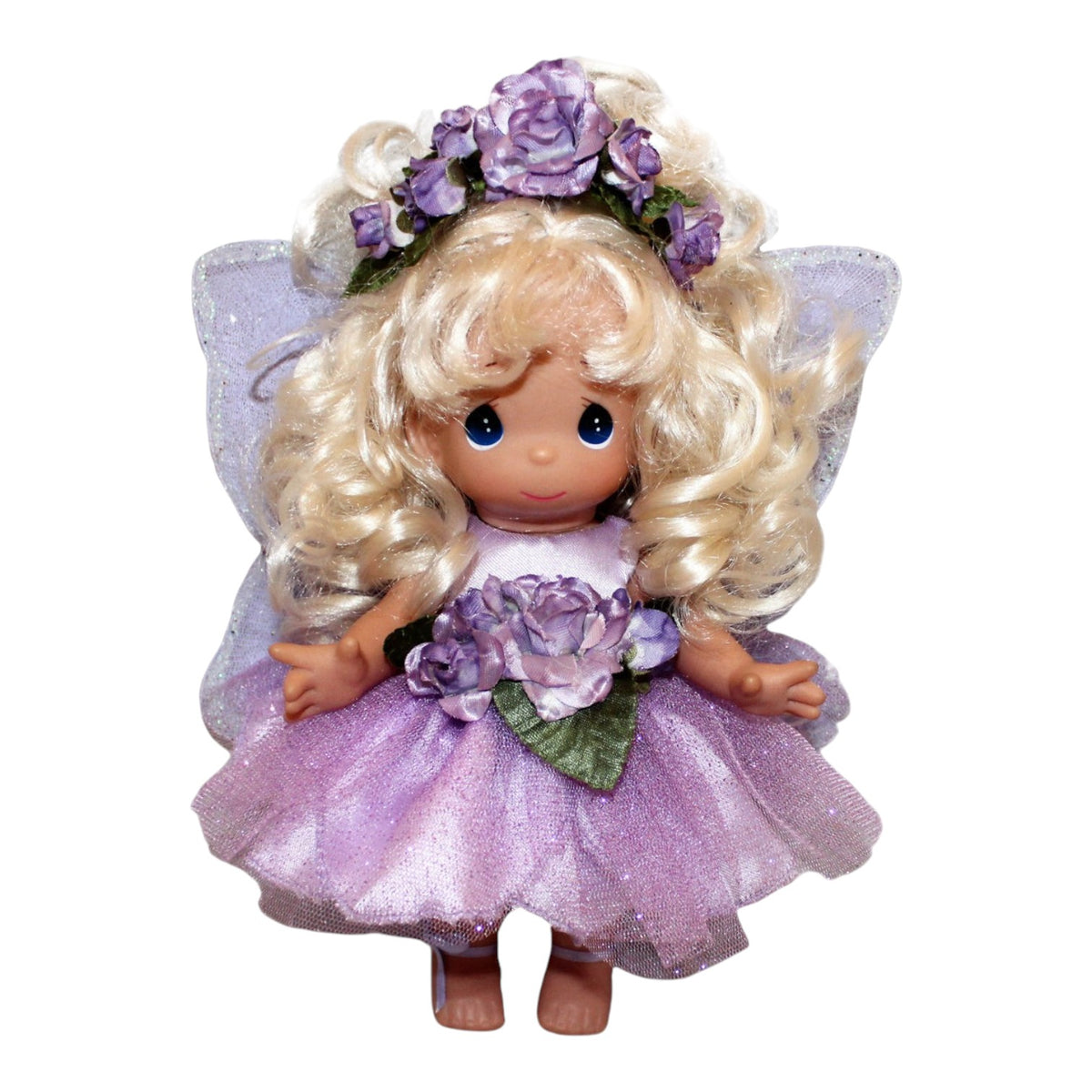 The Doll Maker 9-inch Woodland Fairy Blossom vinyl doll with blonde curls, purple floral crown, and glittery wings.