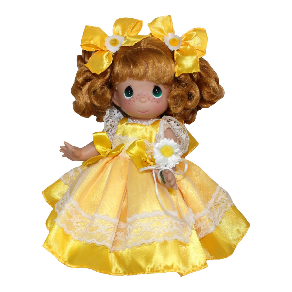 The Doll Maker 12-inch vinyl doll with curly auburn hair, wearing a yellow satin dress with lace and daisy accents.