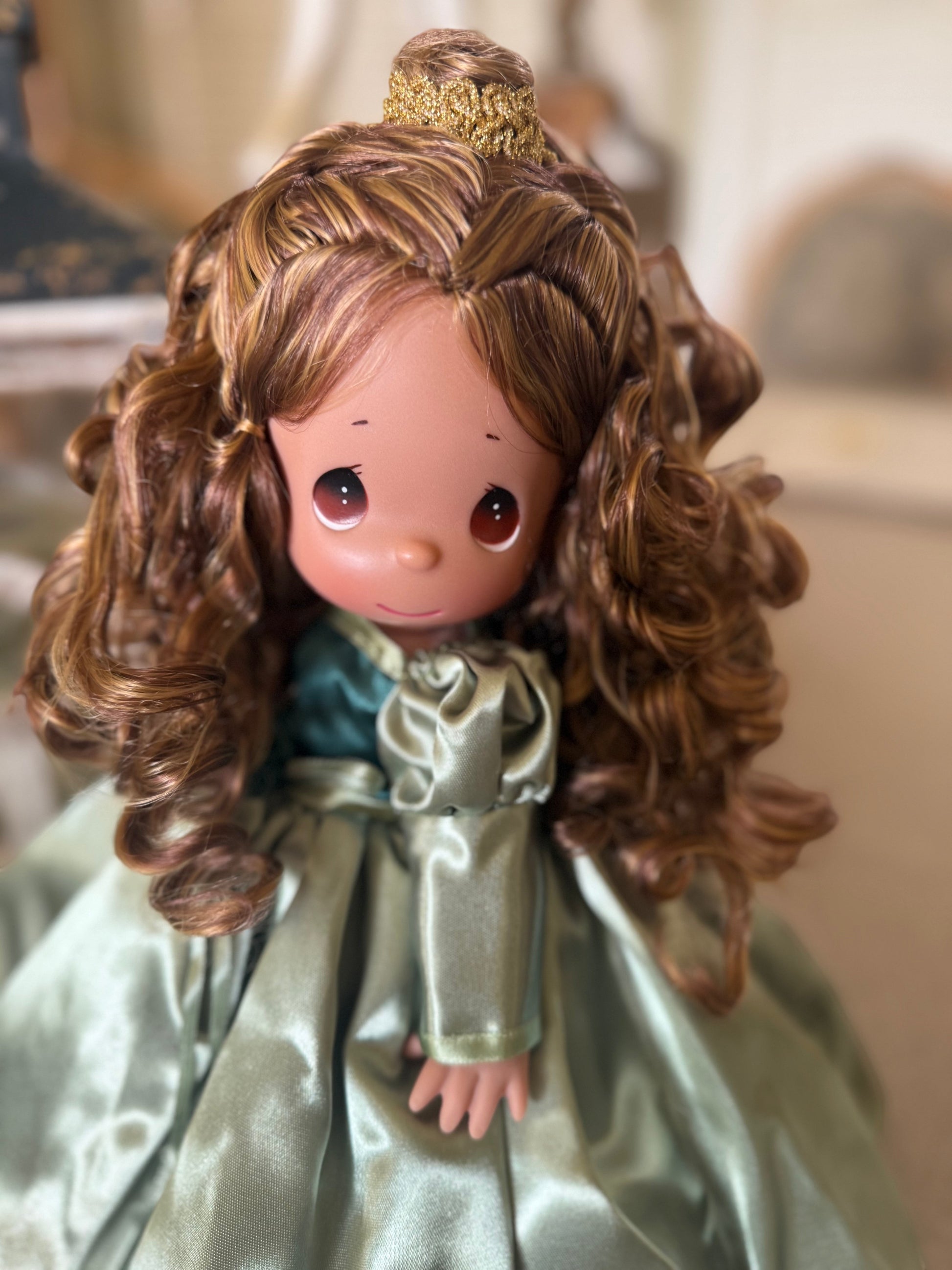 The Doll Maker's Beautiful Belle 12" doll in a satin green gown with curly brown hair.