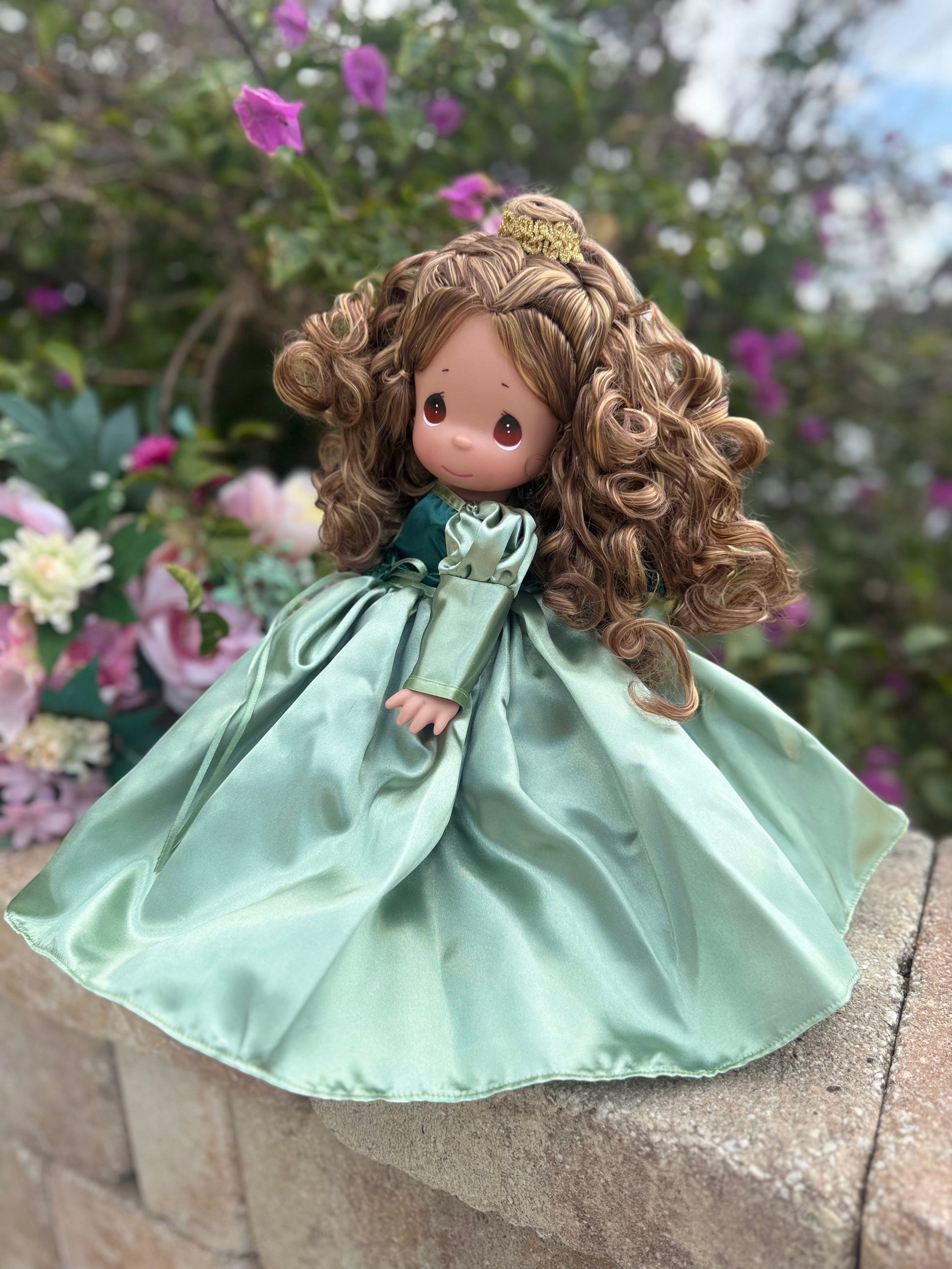 The Doll Maker's 12" Belle doll in a satin green princess gown with curly brown hair