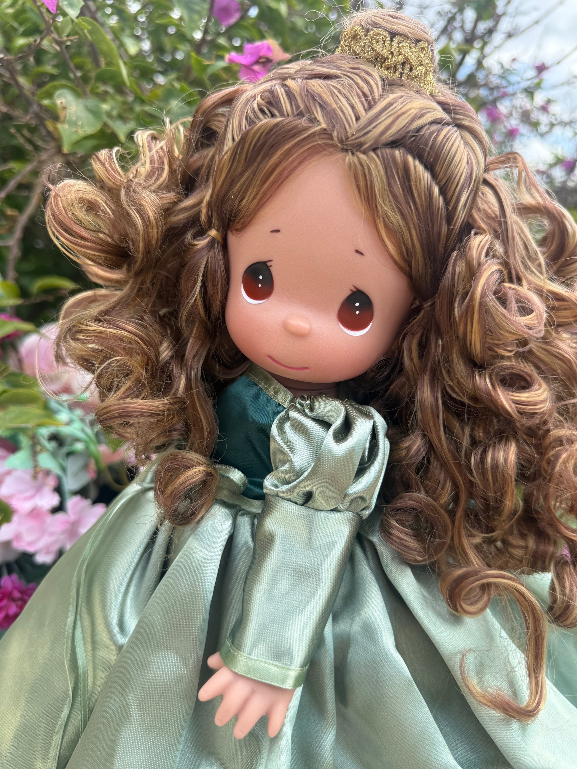 The Doll Maker's Belle doll in a green satin gown with puffed sleeves