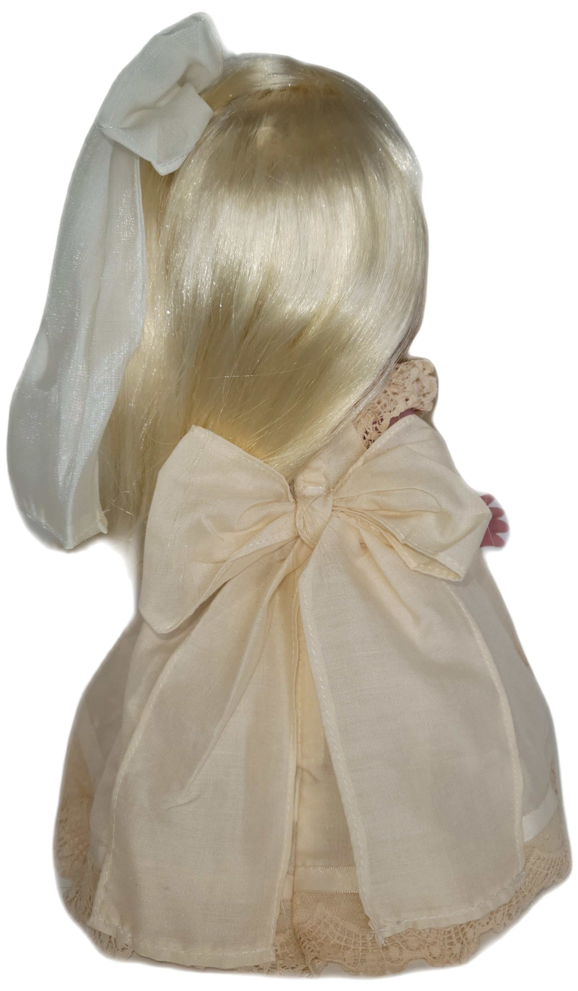 The Doll Maker's Cherish Me Always doll with blonde hair, wearing an ivory lace gown with a large bow.