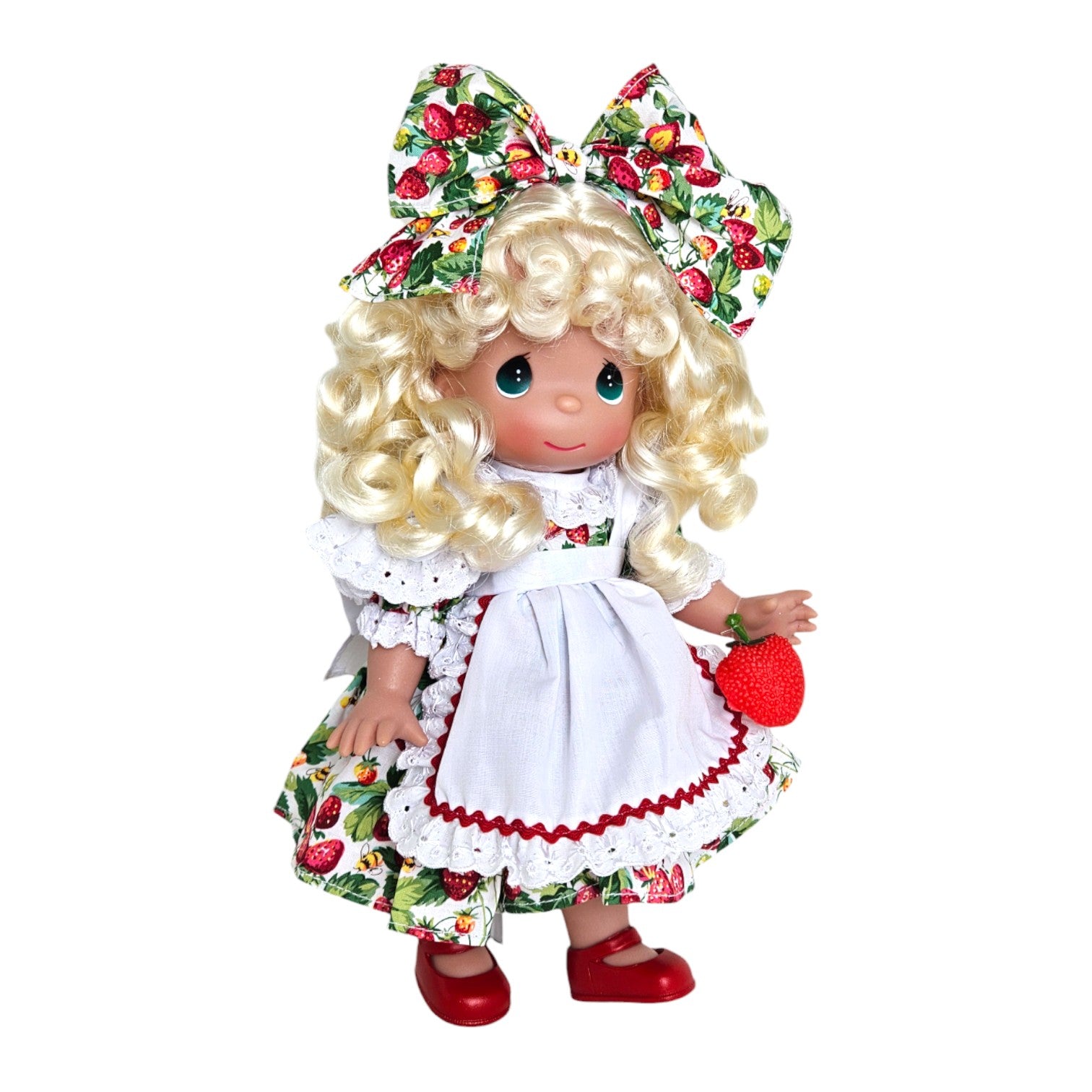The Doll Maker You're Berry Sweet doll with blonde curly hair, strawberry print dress, white apron, and holding a strawberry.